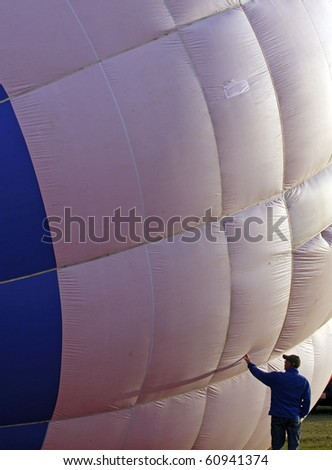 SUSSEX, CANADA - SEPTEMBER 12: A crew member checks the envelope before launch at the 2010 Atlantic International Balloon Fiesta on September 12, 2010 in Sussex, Canada.