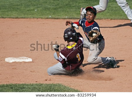 BANGOR, MAINE - AUGUST 18: A close play at second between Josh Raley of Palm Bay, Florida and Mandy Castillo of Philippines at the Senior League Baseball World Series August 18, 2011 in Bangor, Maine.