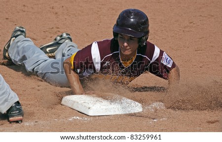 BANGOR, MAINE - AUGUST 18: Kenny Rhodes of Palm Bay, Florida slides safely back to first at the Senior League Baseball World Series against Tanauan City, Philippines August 18, 2011 in Bangor, Maine.