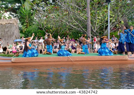 OAHU, HAWAII - DECEMBER 24: Polynesian Cultural Center. Students from University of Hawaii perform a traditional Hawaiian dance on a canoe on Christmas Eve, December 24, 2008.