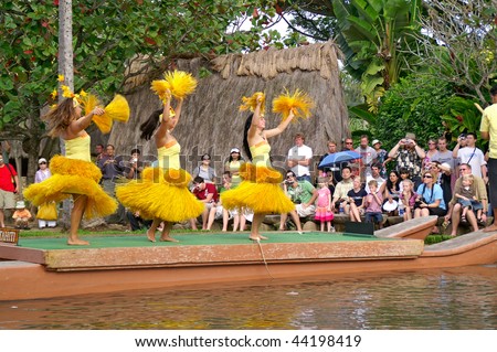 OAHU, HAWAII - DECEMBER 24: Polynesian Cultural Center. Students from University of Hawaii perform traditional Tahiti dance on a canoe on Christmas Eve, December 24, 2008.