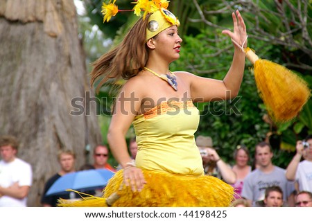 OAHU, HAWAII - DECEMBER 24: Polynesian Cultural Center. Students from University of Hawaii perform traditional Tahiti dance on a canoe on Christmas Eve, December 24, 2008.