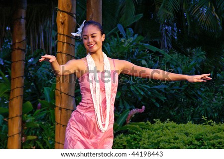 OAHU, HAWAII - DECEMBER 24: Polynesian Cultural Center. Young girl, a student from University of Hawaii in traditional Hawaiian dress performs hula dance on Christmas Eve on December 24, 2008.