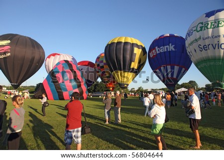LISLE, IL - JULY 3: Hot Air Balloons prepare to takeoff in the morning sky at the Annual Hot Air Balloon Festival Eyes to the Skies and for celebration of Independence Day on July 3, 2010 in Lisle, IL