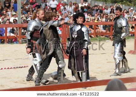 KENOSHA, WI - SEPTEMBER 4: Actors as medieval knights perform a dispute regarding the tournament at the annual Bristol Renaissance Faire on September 4, 2010 in Kenosha, WI