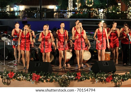 PALM BEACH, ARUBA - DECEMBER 23: Band from attractive girls perform traditional Aruban songs for Christmas celebration on December 23, 2010 in Palm Beach, Aruba