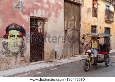 HAVANA, CUBA, FEBRUARY 15, 2014 : Bike taxi in Cuba street of Havana. Havana is the largest city in the Caribbean and its center is inscribed on Unesco World Heritage list.