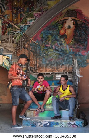 HAVANA, CUBA, FEBRUARY 15, 2014 : People in a painted stair of an old house of Havana. Havana is the largest city in the Caribbean and its center is inscribed on Unesco World Heritage list.
