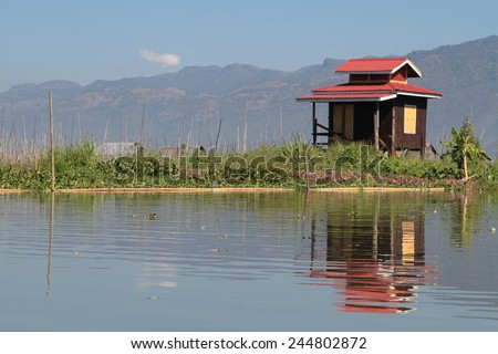 INLE LAKE, MYANMAR, December 14, 2014 : Small house on the Lake. People built on the water its houses on piles and lives on culture of fruits, vegetables and flowers on incredible floating islands