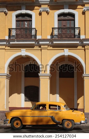 HAVANA, CUBA, FEBRUARY 16, 2014 : Classic old American car in the streets of Havana. Classic cars are still in use in Cuba and old timers have become an iconic view and a worldwide known attraction.