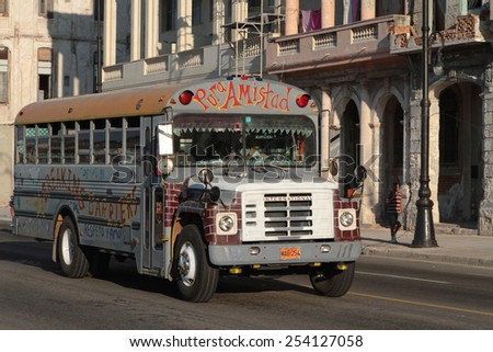 HAVANA, CUBA, FEBRUARY 15, 2014 : Old Bus on Malecon Boulevard of Havana. Classic cars and trucks are still in use in Cuba and old timers have become an iconic view and a worldwide known attraction.