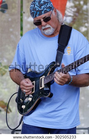 BREAUX BRIDGE, LOUISIANA, May 3, 2015 : Guitarist plays during Crawfish Festival in Breaux Bridge. Breaux Bridge has been designated as the Crawfish Capital of the World