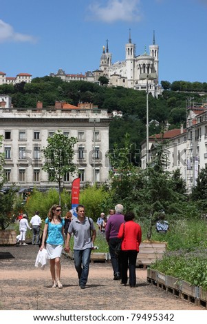 LYON, FRANCE-JUNE 19: Unidentified inhabitants of Lyon visit the Place Bellecour and its temporary gardens during the Nature Capitale Lyon event, in Lyon, France on June, 19, 2011
