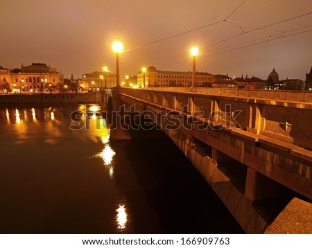 Night view at bridge over river to historical part of town