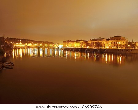 Night view at bridge over river to historical part of town