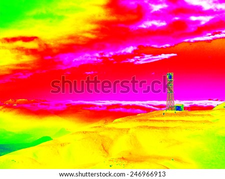 Infrared photo of Alpine winter hilly landscape. Sunny weather with clear sky above. Amazing thermography colors.