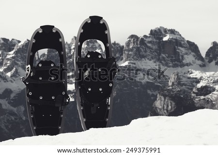 Snowshoes in snow at mountain peak, nice sunny winter day