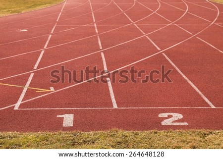 Number one. Number two. White track number on red rubber racetrack, texture of running racetracks in small stadium