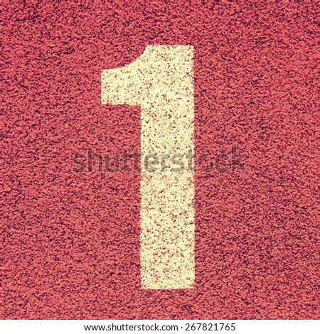 Number one. White track number on red rubber racetrack, texture of running racetracks in small stadium