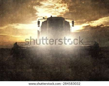 Aquarelle, Watercolor paint. Painting effect. Terrifying combine harvest wheat with lighted main lights in the middle of a farm field. Morning yellow wheat field on the sunset cloudy orange sky.