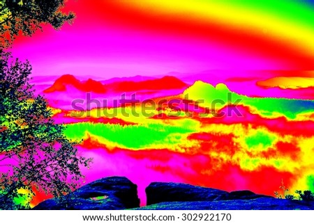 Rock with trees above misty valley. Fantastic infrared scan of hilly landscape. Hill and forest with colorful fog, hot sunny sky above.
