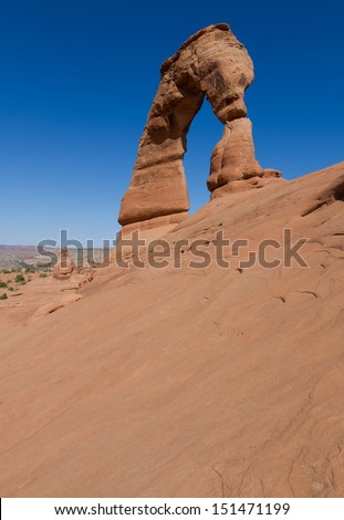 Scenic landscape view of Delicate Arch viewed from an unusual angle on a beautiful sunny day