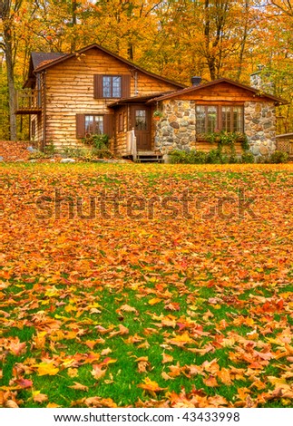 Fall colors around a cottage house in Quebec