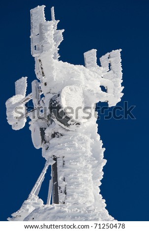Weather station radio antenna covered in snow and ice after a heavy winter snow storm