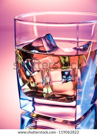 Glass of alcoholic drink in vivid neon colors