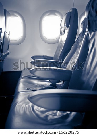 Inside a passenger aircraft, three seats
