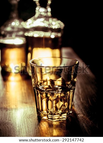 Whiskey on the rocks with back light and strong reflections