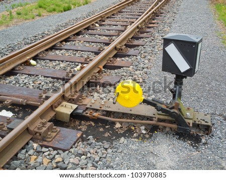 Hand-operated railroad switch with lever, weight and signal