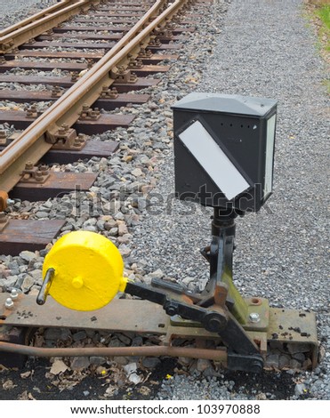 Hand-operated railroad switch with lever, weight and signal
