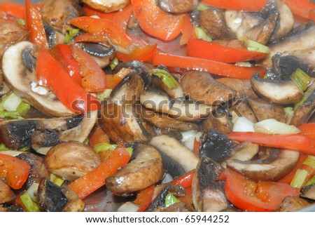 Preparing a mushroom dish with butter mushrooms, pepper, spring onions