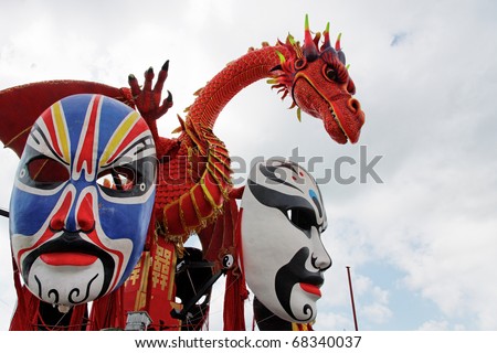 VIAREGGIO - AUGUST 5: A Red Dragon and Huge historical Masks on a japanese themed float during the Carnival of Viareggio, one of the most famous over Europe August 5, 2010 in Viareggio, Italy
