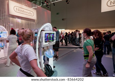 COLOGNE - AUGUST 20: Female Videogamers playing with Nintendo Wii and Just Dance 3 at GamesCom 2011, the most important European video games Expo August 20, 2011 in Cologne, DE
