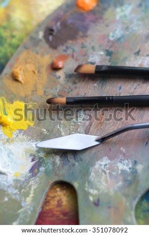 Art palette with paint brushes and a palette knife