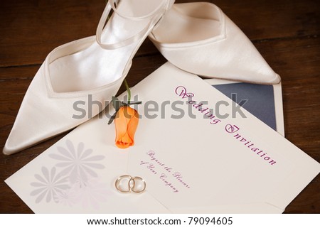 Wedding invitation with rings and bride shoes. Clipping path on text area
