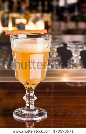 Yellow cocktail with cinnamon decoration