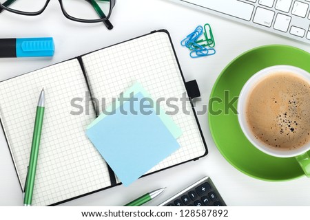 Green Coffee Cup And Office Supplies. View From Above. Closeup
