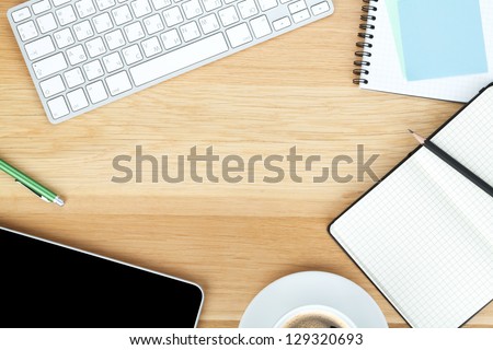 Office supplies, gadgets and coffee cup on wooden table