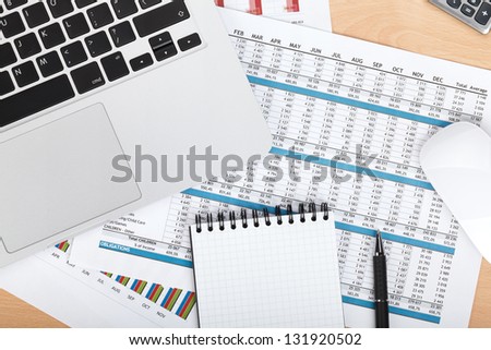 Financial papers, computer and office supplies closeup