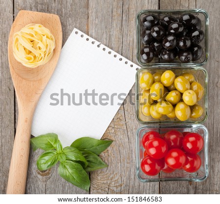 Blank notepad paper for recipes and fruits on wooden table
