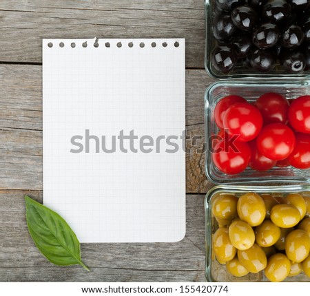 Blank notepad paper for your recipes and fruits on wooden table