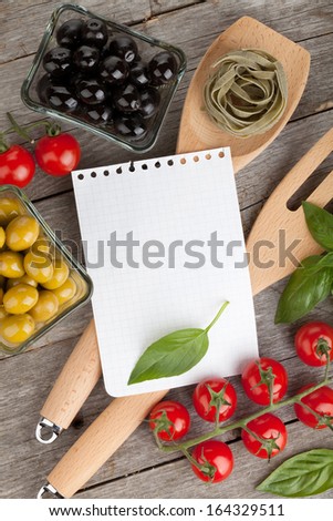 Blank notepad paper for your recipes and food on wooden table