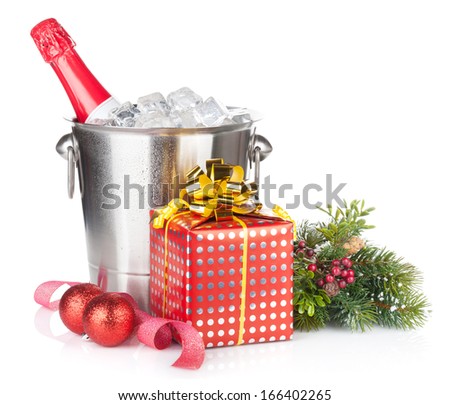 Champagne bottle in ice bucket, two glasses and christmas gift. Isolated on white background