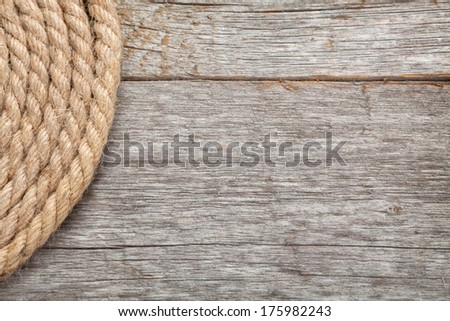 Roll of ship rope on wooden texture background