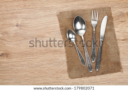 Silverware or flatware set of fork, spoon and knife on wooden table