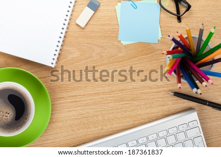 Office table with coffee cup, supplies and copy space