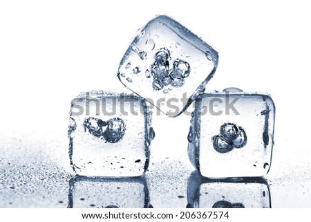 Three melting ice cubes with water dew on white background